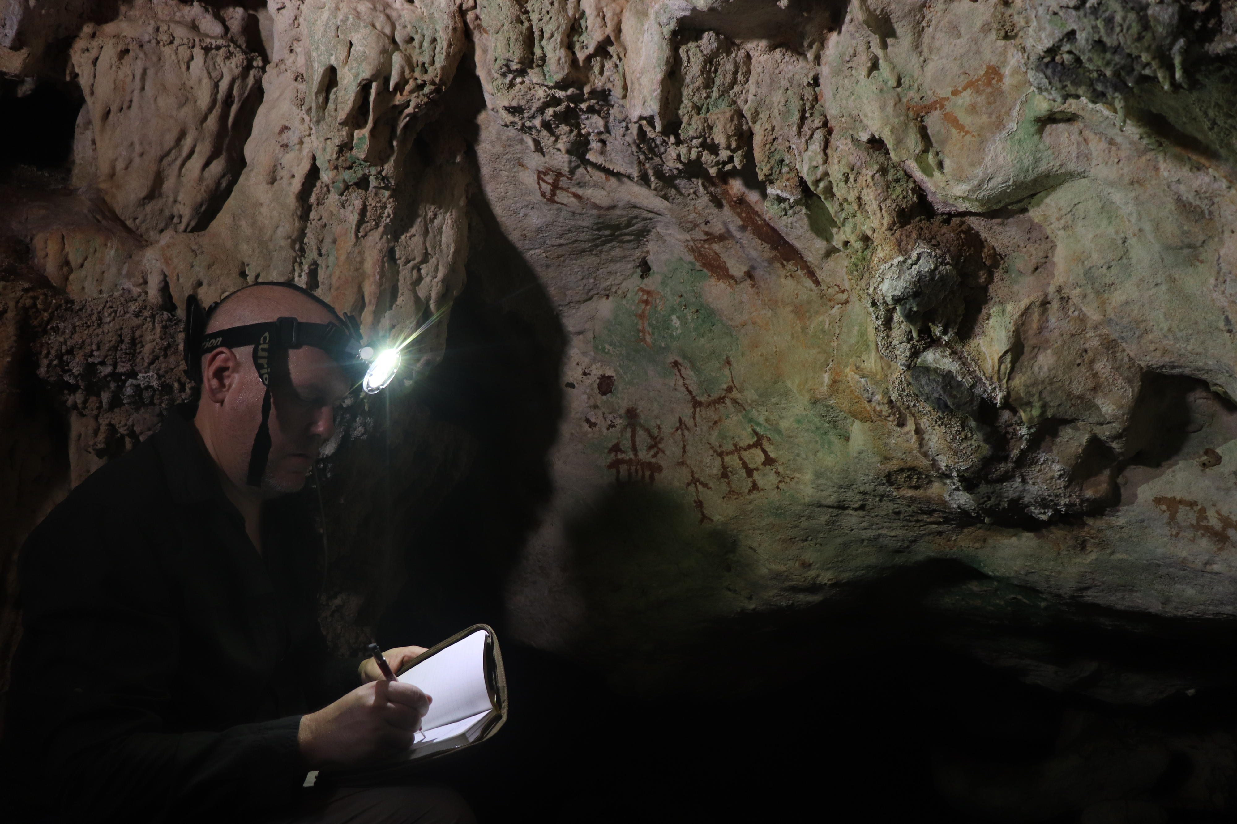 Professor Maxime Aubert working in the cave Professor Maxime Aubert working in the cave